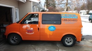 Water Damage Restoration Van At Winter Residential Job Area