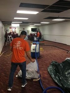 Technicians Conducting Flood Cleanup In A Commercial Property