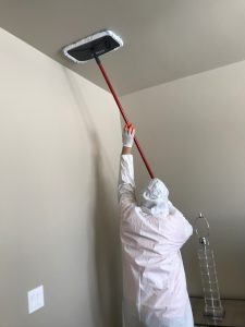 Our Technician Cleaning Ceiling Water Damage and Mold